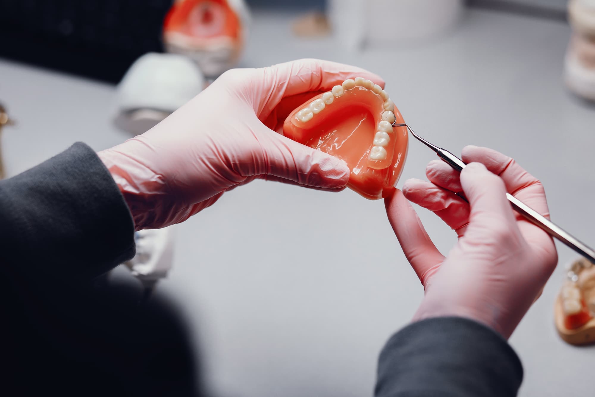 Acrylic denture being repaired by technician